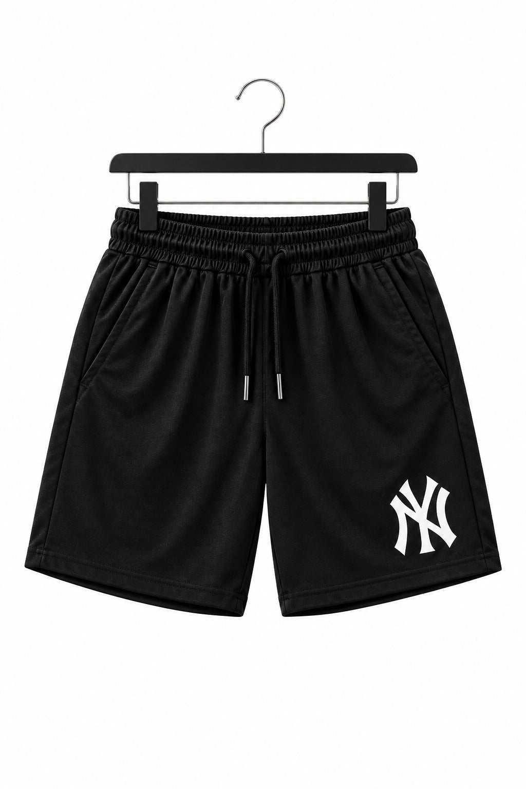Black athletic shorts with a white New York Yankees logo on the lower left leg, hanging on a black hanger against a white background.
